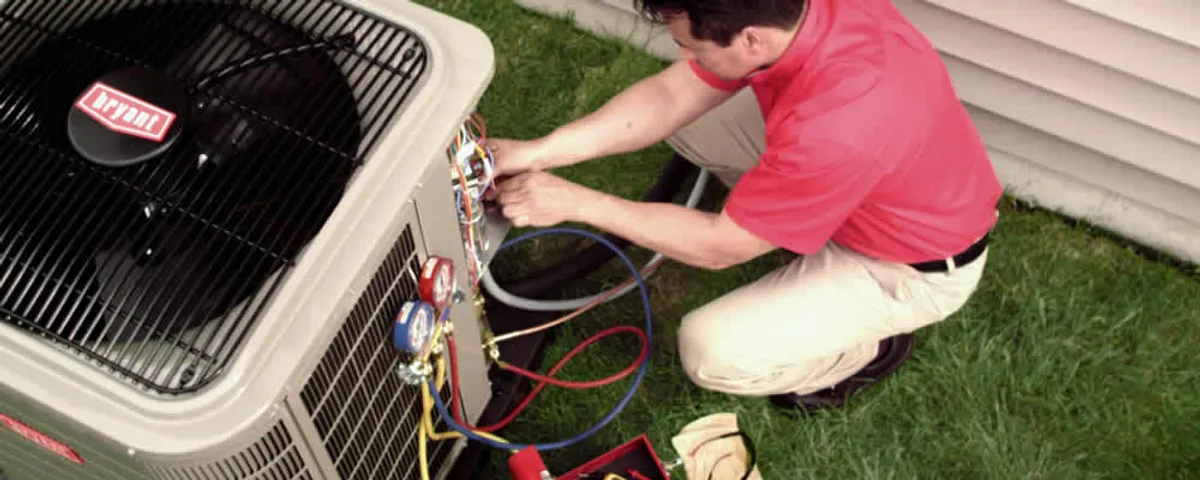 HVAC technician servicing an outdoor air conditioner unit in Fresno, CA